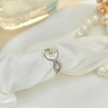 Vintage silver sunburst star ring with zircon stone on elegant white silk fabric - Adjustable Open / Silver with White Zirconia