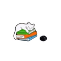 Cartoon white cat resting on colorful books enamel pin with a black rubber backing - White Cat on Stacked Books