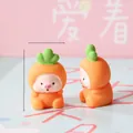 Macro detail of cute mini pig figurines wearing orange carrot costumes for micro landscape - Carrot Costume Pig