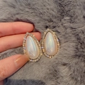 Macro detail of pear-shaped pearl earrings with gold base and shimmering crystal border - 18# Gold Pearl Drop