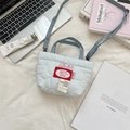 Flat lay of light blue quilted mini tote bag with cherry patch and denim strap detail - Light Blue