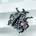 Macro shot of colorful rhinestone beetle brooch with pink and blue stones on black base - Style 1-Black Base Multi-color Beetle