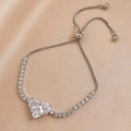 Elegant adjustable silver heart bracelet with cubic zirconia on champagne silk backdrop - Zircon Heart (HB779) / Silver