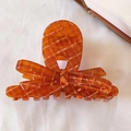 Elegant amber checkered bow-shaped hair claw clip on white fabric background - Streamer Style / Orange Plaid
