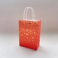 Red paper gift bag with golden star pattern and white paper twist handles in variant style - Orange Single-Sided Bronzing Star