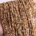 Close-up of 2mm-3mm natural stone beads in brown and beige for jewelry making - Picture Jasper