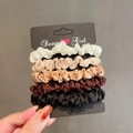 Set of 5 elegant French satin scrunchies in neutral colors on a black display card - Set of 5