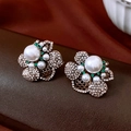 Close-up of vintage flower stud earrings with large white pearls and green rhinestones - Floral Style (Silver Post) / Gold-White-Green