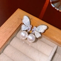 Macro shot of silver butterfly earrings with sparkling crystals and twin white pearls - Butterfly Double Pearl Style (Silver Earring Post Style 4)