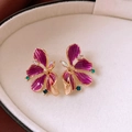 Macro detail of vintage purple enamel flower earrings with sparkling rhinestones - Gold Purple Drip Oil Flower