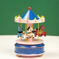 Close-up of carousel music box with hand-painted horses and gold star star-topped canopy - Dot Blue and Pink