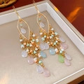 Detail of colorful acrylic beaded fringe earrings with golden leaf hooks and teardrop pendants - Multicolor-Pink