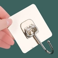 Hand holding a strong adhesive wall hook with stainless steel metal and clear base - Brushed Large Hook