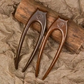 Detailed view of U-shaped sandalwood hairpins with crab claw carving and natural grain - Double Prong Bear (Zebrawood)