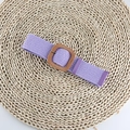 Close-up of purple woven elastic belt with a square wood-textured buckle on straw mat - Square Buckle Purple