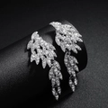 Sparkling silver wing drop earrings with white crystal rhinestones on a black background - Silver