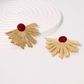 Detailed close-up of fan-shaped golden earrings with a deep red center on a white background - Burgundy