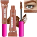 Detailed view of brown brow mascara with fiber brush applicator and swatch effects - Rich Auburn