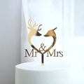 Close-up of golden Mr & Mrs cake topper with deer silhouettes in a heart frame - Gold Deer Heart Shape MR&MRS
