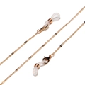 Detailed view of golden metal eyewear chain with white silicone loops and lobster clasps - Style 8-Thin Loop Chain / Gold