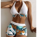 Close-up of high-waist boyleg swim shorts with vibrant tropical leaf print and white trim - S / White