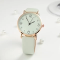 Detailed close-up of a minimalist mint green watch with rose gold case on white background - Green