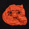 Halloween decoration set featuring bright orange cobweb and two black plastic spiders - 20g Spider Cotton Orange