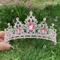Close-up of bridal crown featuring pink teardrop gemstones and clear rhinestones - Silver + Pink Rhinestone