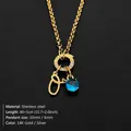 Gold plated stainless steel necklace with letter O charm and blue gemstone pendant detail - Letter O