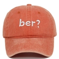Macro detail of retro washed cotton baseball cap with blue ber? embroidery on deep orange - Orange