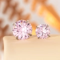 Pink firework cut zircon stud earrings in silver-colored claw setting on a beige stand - 8mm Zirconia / Light Pink