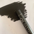 Single professional black oil pastel stick showing creamy texture and dark pigment - Black