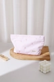 Detail of pink striped makeup bag with heart embroidery on a wooden tray with lipstick - Large / Pink