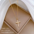 Macro view of gold cross pendant with crystal inlay and technical specifications - Gold