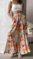 Detail shot of bohemian floral wide leg trousers with elastic high waist and breezy fit - Multicolor Print