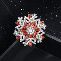 Silver snowflake brooch with clear and red rhinestones on a black display stand - Silver with Red Zirconia