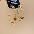 Close-up of vintage gold earrings with tiger eye stones and zircon star accents - Gold Plated Copper + 925 Silver Pin + Tiger's Eye / Star Hoop Earrings (HE29836)