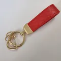 Red braided leather keychain with polished gold-tone metal ring and luxury diamond texture - Red (Gold Hardware)