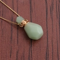 Macro shot of green aventurine flame-shaped perfume bottle pendant with golden chain - Light Green Essential Oil Bottle Style (NSN0233)