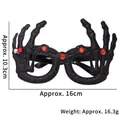 Glittering black Halloween skull hand glasses with red gems and small bell accessory - Skeleton Hand Glitter