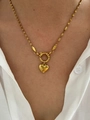 Detailed close-up of golden heart pendant on a twisted chain necklace worn by a model - Golden Heart Pendant Necklace