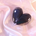 Black heart-shaped makeup sponge in a clear heart case on pink silk background - Black Heart/OPP Bag