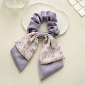 Detail view of purple floral double-layered bow hair scrunchie on decorative stone plate - Double Layer Bow / Soft Purple