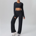 Detail van zwarte crop top met lange mouwen en yoga broek met hoge taille en wijde pijp - S / Zwart