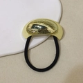 Minimalist U-shaped alloy hair tie in gold finish with black elastic band on beige fabric - Simple U-Shape - Gold