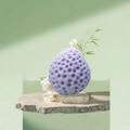 Purple teardrop honeycomb bath sponge with hanging rope on stone pedestal - Purple
