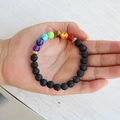 Close-up of chakra bracelet with black lava stone, colorful beads and metal spacers - Lava Rock Bracelet