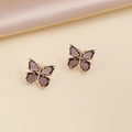 Macro shot of butterfly earrings featuring purple crystals and gold-tone metal borders - 18# Dark Purple Stud Earrings