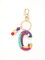 Close-up of colorful wooden letter C keychain with decorative multi-colored beads and gold clasp - Letter C Style