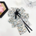 Elegant white floral bow hair claw clip with yellow flowers and black ribbon detail - Floral Daisy